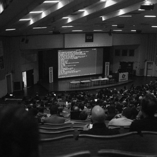 Black and white shot of a technology conference at ULB auditorium, Brussels.